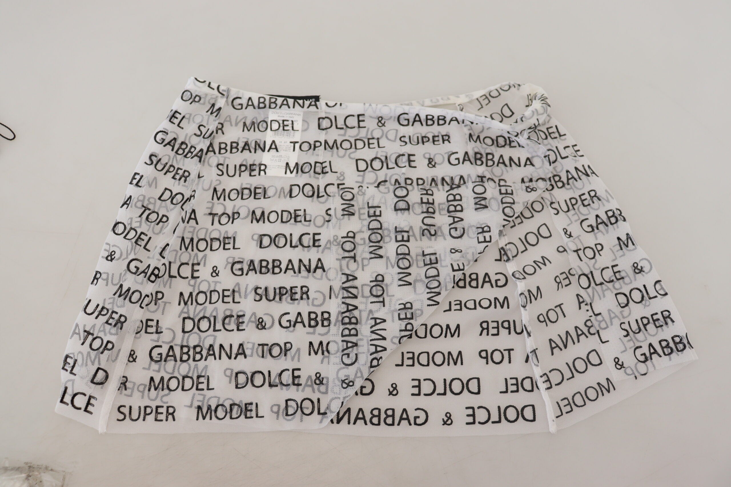 Dolce & Gabbana White Logo See Through A-line Mini Skirt -   -  Dolce & Gabbana. Dolce & Gabbana White Logo See Through A-line Mini Skirt -   -  Dolce & Gabbana.